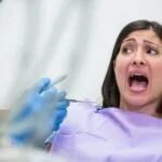 Patient overcoming dental anxiety during implant procedure at Topeka Oral Surgery